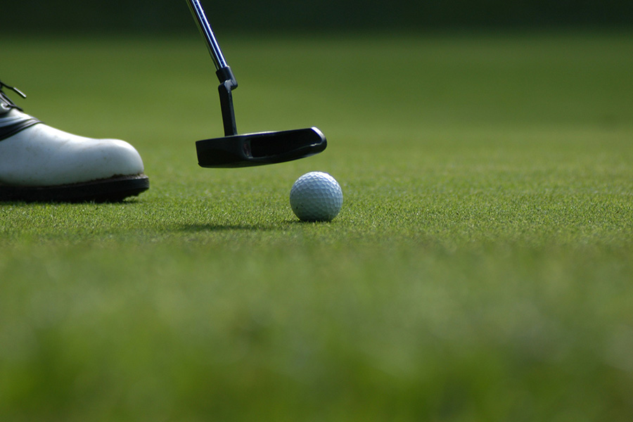Golfer standing on a green